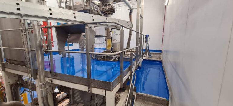 Blue resin sanitary flooring in a gluten-free food production site.