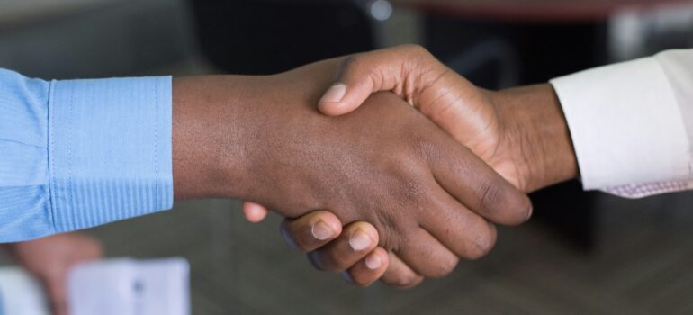 Resin flooring contractor and client shaking hands after closing a deal