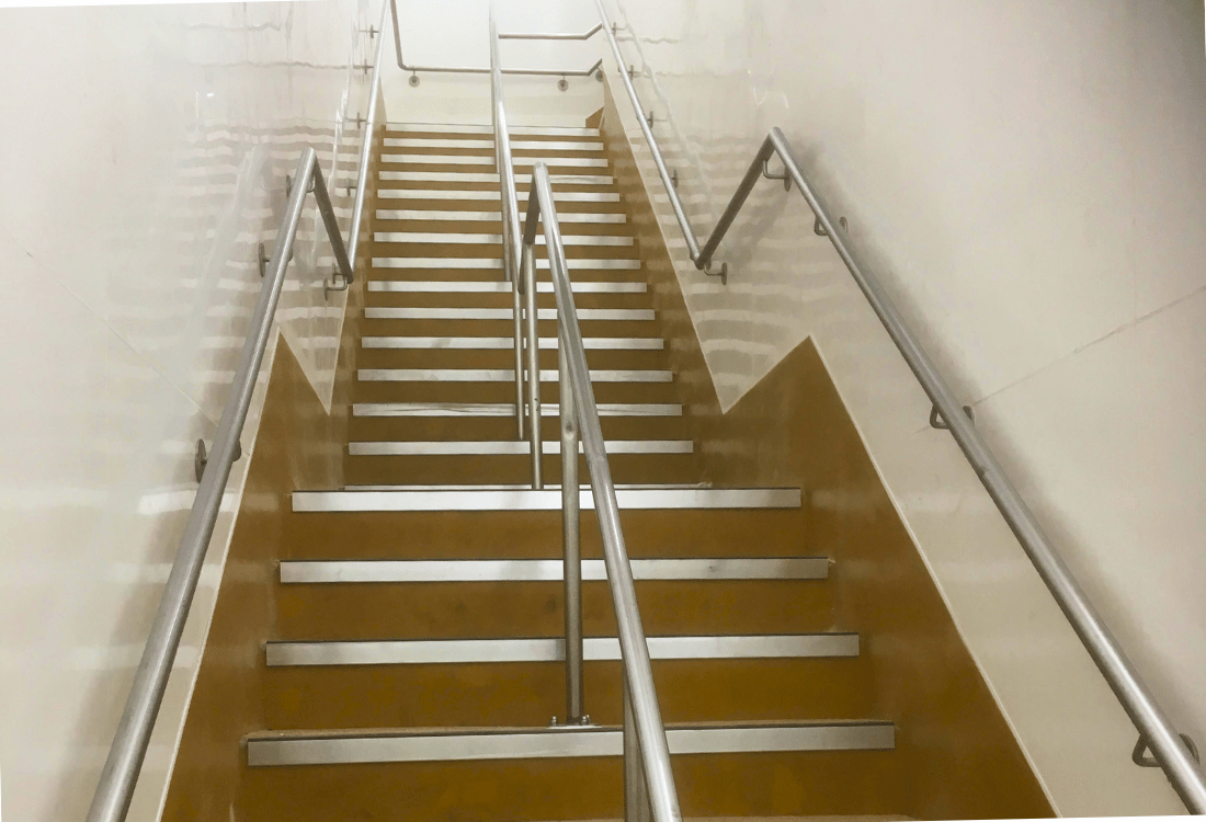 A staircase covered in epoxy flooring at a school or educational facility.