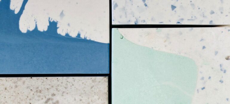A sample of epoxy flooring showing 4 squares of bespoke resin flooring.