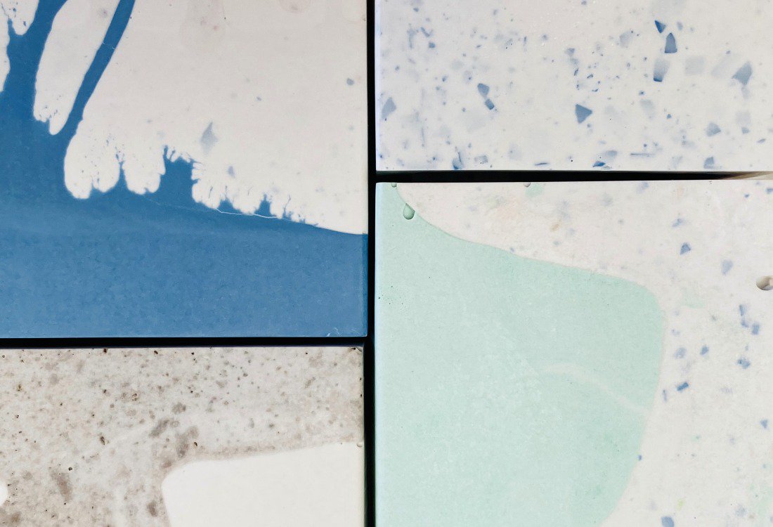 A sample of epoxy flooring showing 4 squares of bespoke resin flooring.