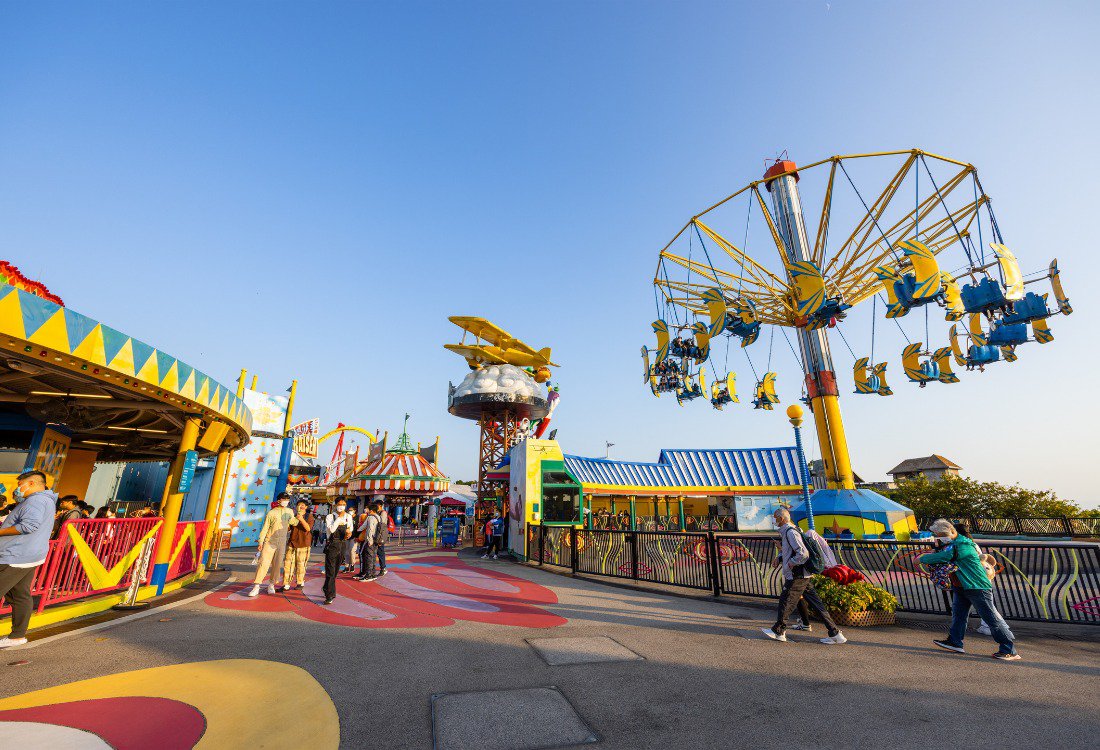 Various flooring samples like rubber, poured-in-place, and interlocking tiles, suitable for theme parks.