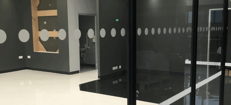 Modern retail shop floor featuring sleek, durable resin flooring, highlighting style and practicality for a contemporary shopping environment.