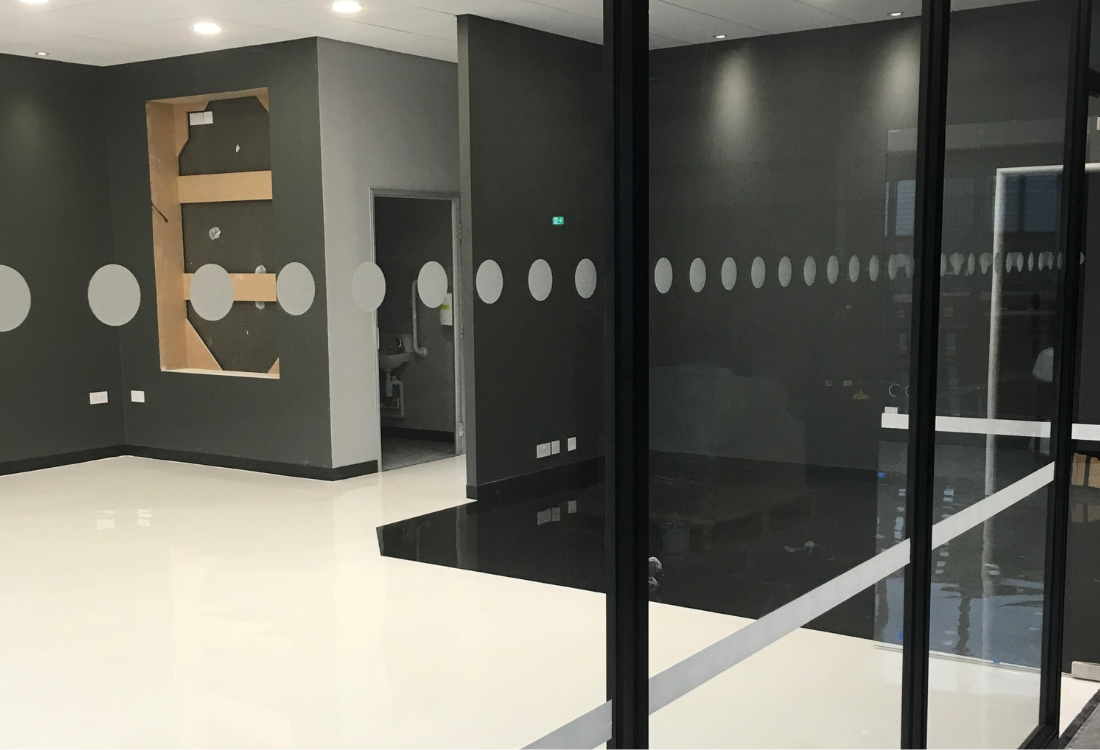 Modern retail shop floor featuring sleek, durable resin flooring, highlighting style and practicality for a contemporary shopping environment.